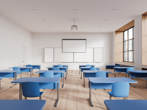 Cozy classroom interior with desk in row and blackboard with screen, window