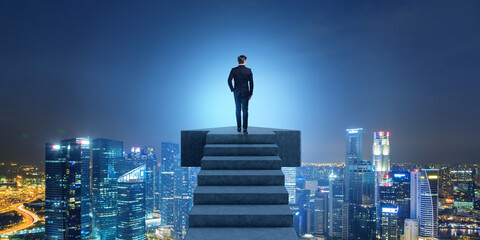 Businessman on top of the stairs, Singapore cityscape buildings at night