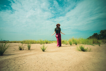 casual woman standing on dirt ground with upset acting