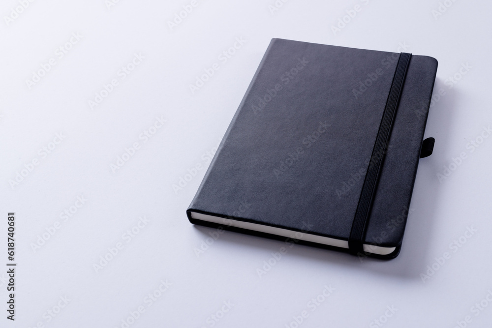 Poster close up of black notebook with copy space on white background
