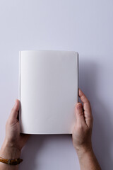 Hands of caucasian woman holding book with copy space on white background