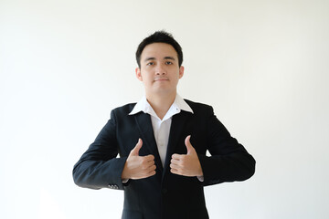 A young Asian businessman is giving double thumbs up by his both hands to the camera. Isolated white background.