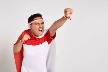 Excited Young Asian man superhero gesturing take off hands ready to fly isolated over white...