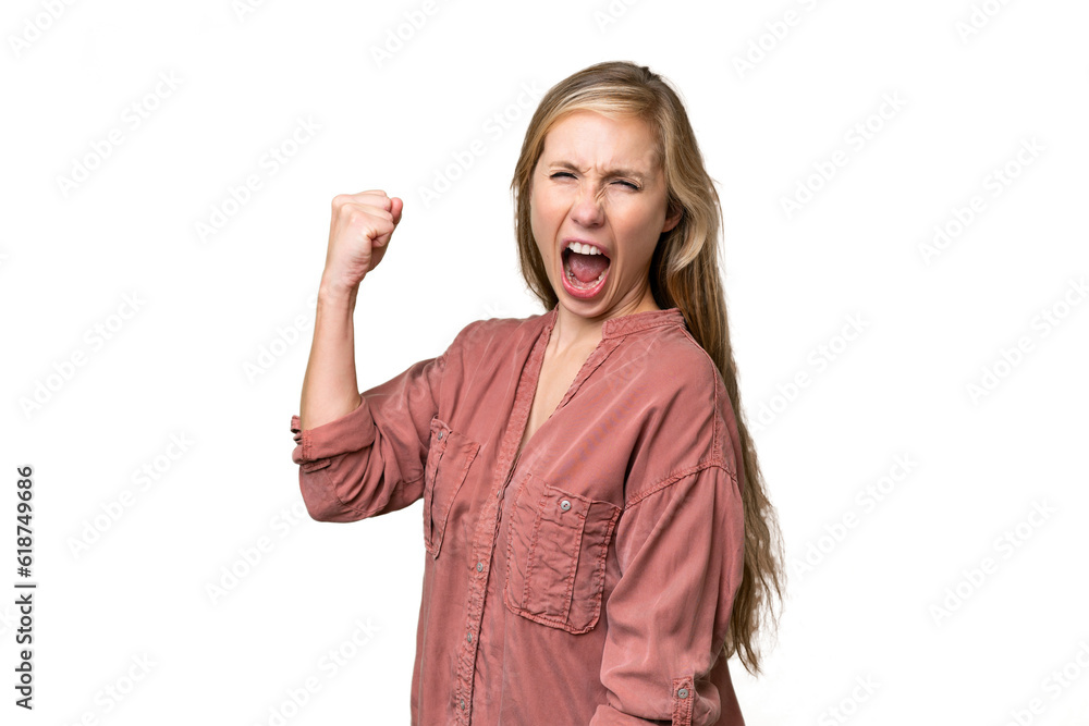 Wall mural Young blonde woman over isolated background celebrating a victory