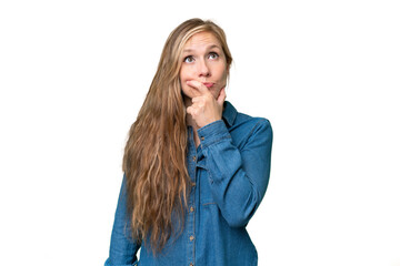 Young blonde woman over isolated background having doubts and with confuse face expression