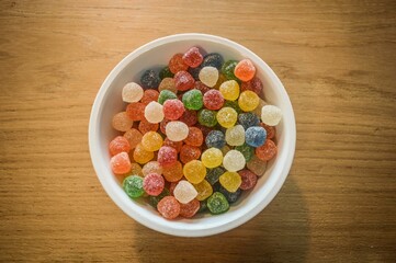 Ceramic bowl filled with colorful jelly-like candies