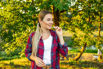 Young beautiful woman wearing red shirt over holding an invisible aligner. Dental healthcare and confidence concept. Places for text