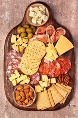 Macro food photography of antipasto, cheese, cheddar, cracker, parmesan, salami, prosciutto, feta,...