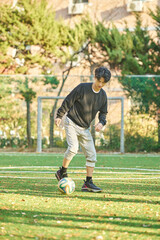 Asian Korean young male college athlete model controlling the ball with his feet and chest