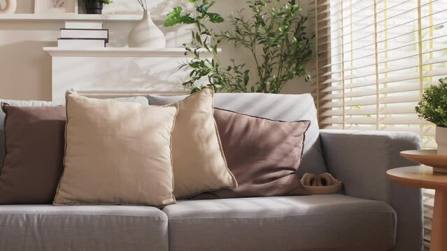 home interior design detail of Modern clean living room with soft and cosy sunlight pillow upholstery cushion arrange on white sofa dolly shot close up,home sweet home background