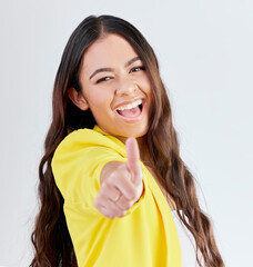 Portrait, support and woman with thumbs up, excited or achievement on a white studio background....