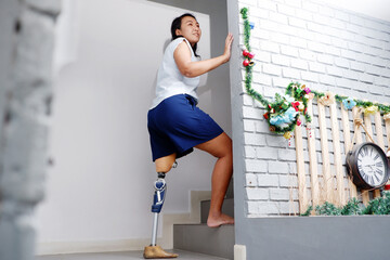 Disabled woman with prosthetic legs walking up the stairs Prosthetic legs.