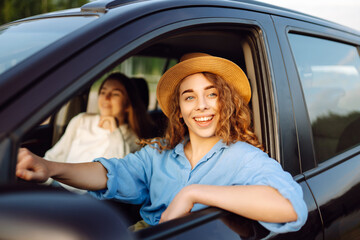 Two Young woman is resting and enjoying the trip in the car Automobile journey, traveling,...