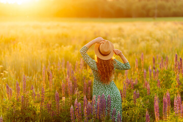 Beautiful  woman in style dress on blooming fragrant lavender fields. Nature, vacation, relax and...