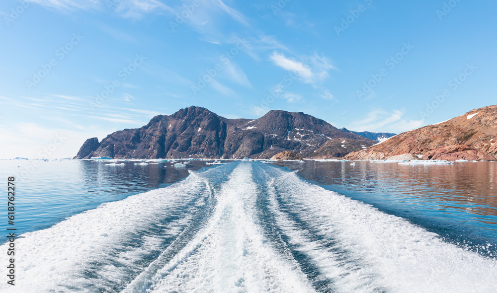 Wall mural fast moving motorboat trying to get out of the ice with rainbow in dense fog - stranded icebergs in 