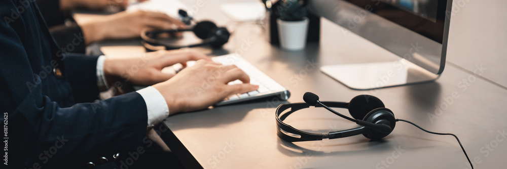Aufkleber panorama focus headset on call center workspace desk with blur background of operator team or telesa