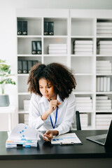Business woman using tablet and laptop for doing math finance on an office desk, tax, report, accounting, statistics, and analytical research concept in office