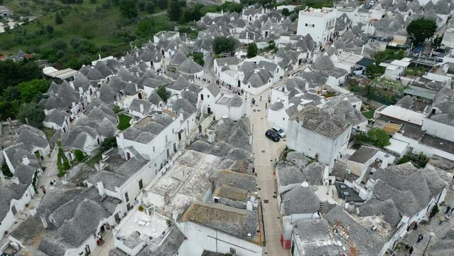Drone footage of Alberobello town in Italy with white trulli huts