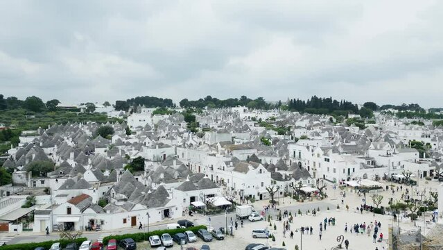 Drone footage of Alberobello town in Italy with white trulli huts