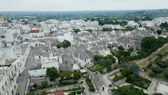 Drone footage of Alberobello town in Italy with white trulli huts