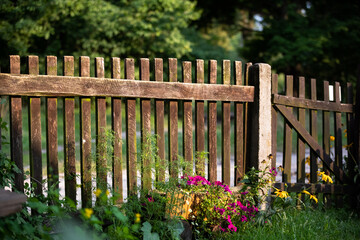 Wooden old fence, composed of many rails in the sunshine.