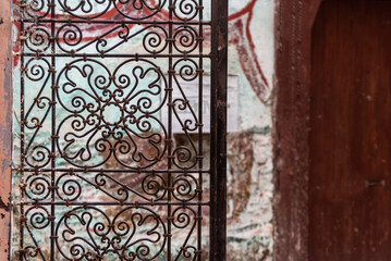 Old ornamental door grille with a floral pattern in the medina of Fes