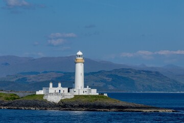 Fototapeta na wymiar Lighthouse in the Firth of Lorne on the island of Eilean Musdile
