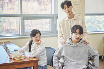 Asian Korean university library desk chair woman sitting on laptop and reading book and man helping...