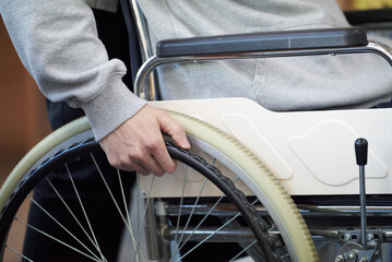 Obraz premium Close-up of hand holding wheelchair in Asia Korea