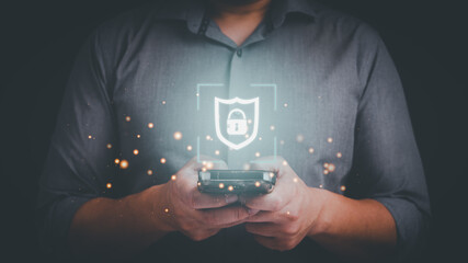 Business man typing on mobile phone with shield and lock icon. Security protection on smartphone application, mobile banking application concept.