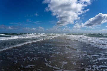 Pristine beach with white sand and azure blue ocean water in the background in Denmark.