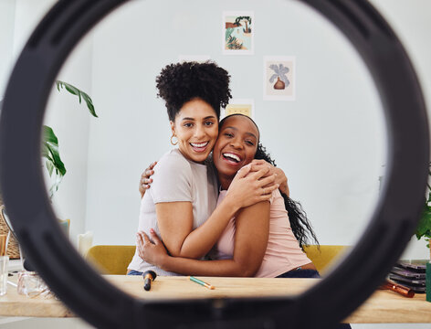 Women, friends and portrait with ring light for social media, makeup tutorial and smile. Young people, women and hug with internet app and happy from influencer and cosmetics vlog at home in bedroom