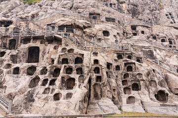 Longmen Grottoes hillside, which contains hundreds of caves with carved Buddha statues, Luoyang, China