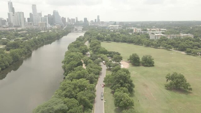 Drone view of Zilker Park with river and trees and downtown buildings in Austin city Texas