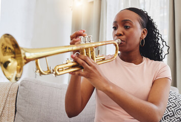 Music, sofa and woman in home with trumpet, sound and band practice for orchestra concert in living...
