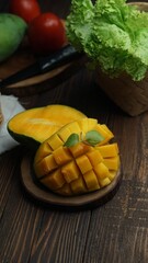 Mango slice cut to cubes on wooden background. Healthy concept photography