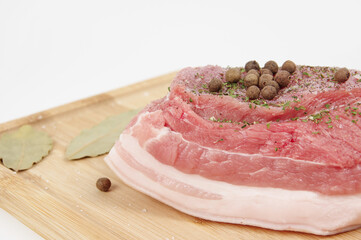 
raw pork meat on a wooden cutting board