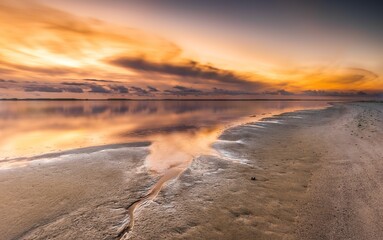 Landscape of a beach surrounded by water during the sunset on Cape Cod, Massachusets
