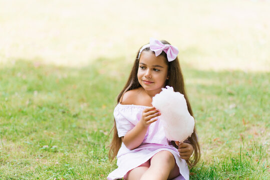 Girl eating white sweet cotton candy