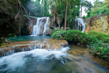 Fototapeta na wymiar Waterfall in tropical rainforest with green tree forest in Phayao north of Thailand