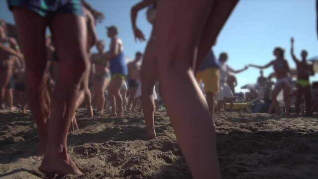 People dance on the beach