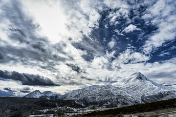 Obraz premium Scenic view of Palentina Mountain covered with snow under a cloudy blue sky in Spain