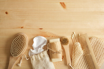 eco self care kit, bamboo and tin items, cotton sponges and homemade soap on wooden background