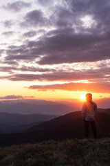 man, tourist in the background, landscape in the mountains, sunset, silhouettes of the peaks, the Montenegrin mountain range, the Carpathians, travel, hikes, screensaver, poster, poster, cover, spring