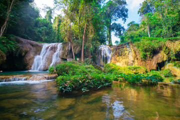 Fototapeta na wymiar Waterfall in tropical rainforest with green tree forest in Phayao north of Thailand
