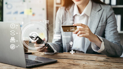 Woman hand holding laptop, smartphonet and using credit card for online shopping. Online shopping concept.