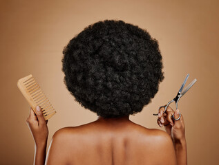 Back, comb and scissors with a black woman in studio on a brown background for a haircut. Salon,...