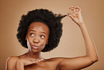 Hair care, black woman and natural afro for beauty in studio isolated on a brown background. Growth, hairstyle and African female model pose with cosmetics after salon treatment for healthy wellness