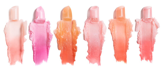 A variety pastel two tone chopped Lipstick bullets and smears/ swatches/ squashed cut out on white background in a row with a shadow