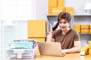 Startup small business entrepreneur SME, asian man receive order on phone. Portrait young Asian small business owner home office, packing boxes, SME sellers, e-commerce team, online sales